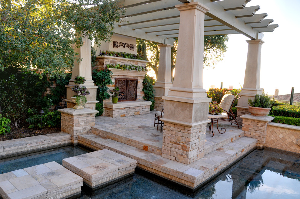 Pool - mid-sized mediterranean backyard stone and custom-shaped lap pool idea in Orange County