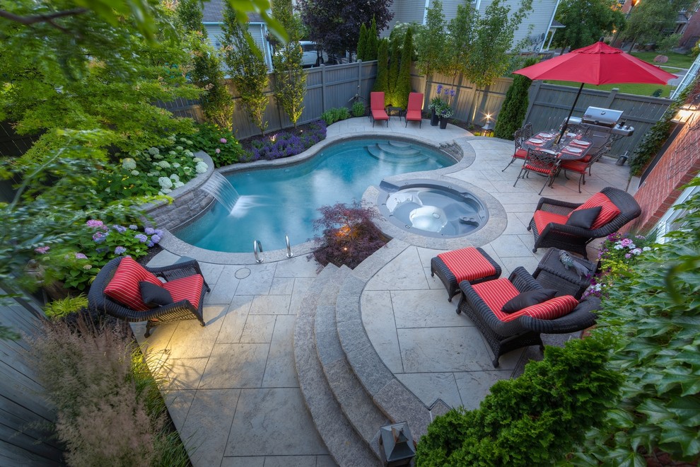 Design ideas for a small contemporary back custom shaped swimming pool in Toronto with stamped concrete and a water feature.