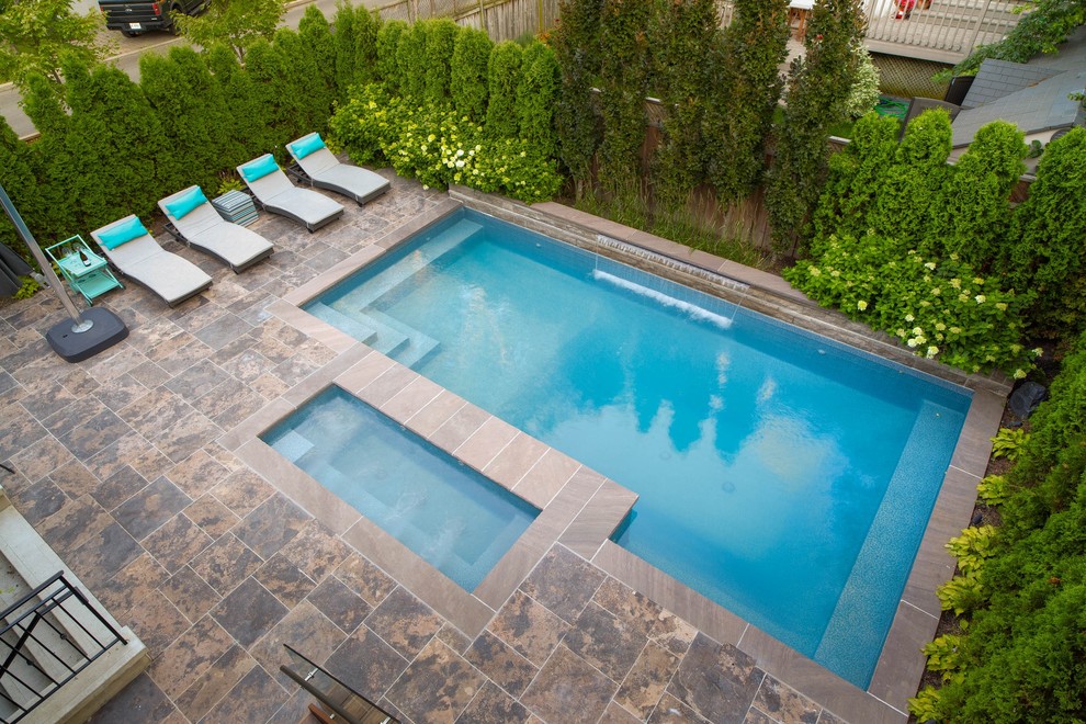 Inspiration for a small classic back rectangular hot tub in Toronto with natural stone paving.