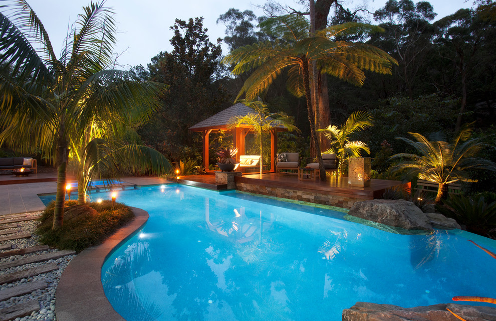 Mid-sized island style backyard stone and custom-shaped natural pool house photo in Sydney