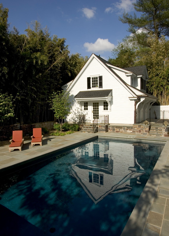 Inspiration for a classic rectangular swimming pool in Other with a pool house.