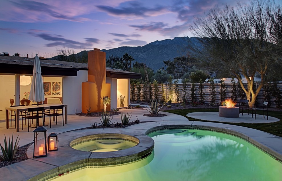 Inspiration for a mid-sized 1950s backyard concrete paver and kidney-shaped hot tub remodel in Los Angeles