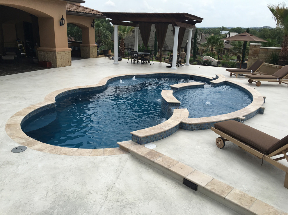 Pool fountain - mid-sized modern backyard concrete and custom-shaped lap pool fountain idea in Austin