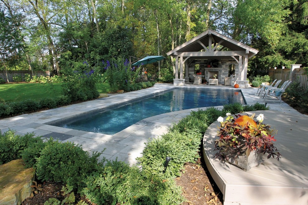 Example of a mid-sized trendy backyard stone and custom-shaped lap pool house design in Toronto