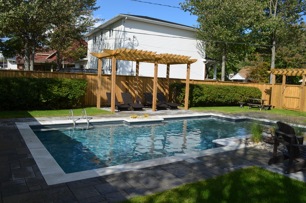 This is an example of a medium sized contemporary back custom shaped swimming pool in Other with concrete paving.