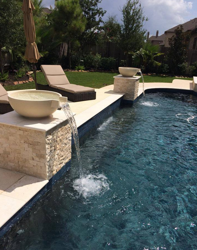 Inspiration for a large contemporary backyard stone and custom-shaped natural pool fountain remodel in Houston