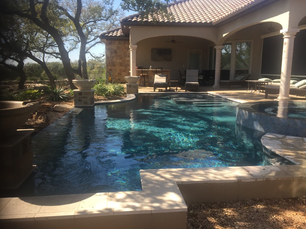 Example of a mid-sized minimalist backyard custom-shaped natural hot tub design in Austin with decking