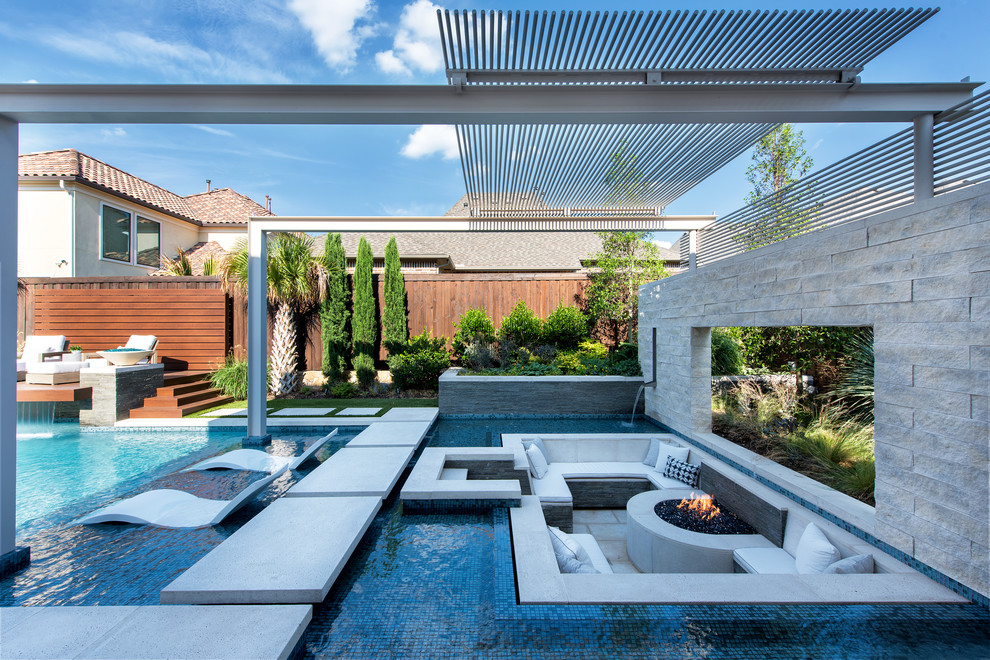 Diseño de piscina mediterránea grande a medida en patio con adoquines de hormigón