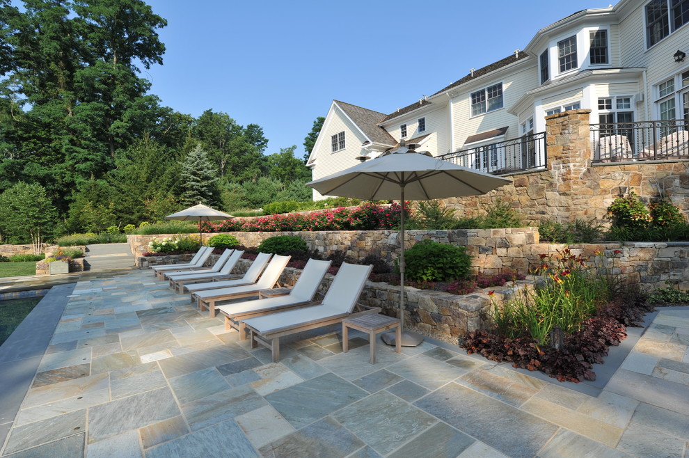 Mid-sized elegant backyard tile and rectangular lap pool photo in New York