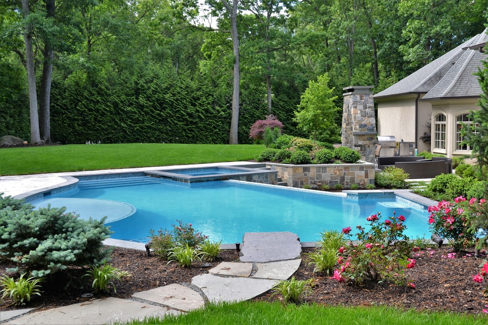 Inspiration for a large modern backyard stone and custom-shaped pool remodel in New York