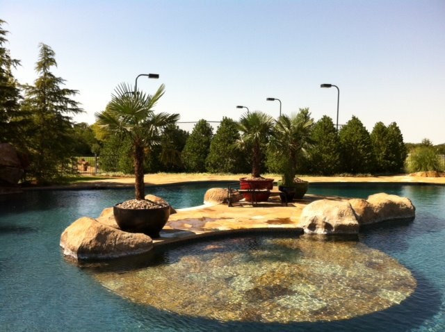 Inspiration for a huge mediterranean backyard stone and custom-shaped natural pool remodel in Oklahoma City