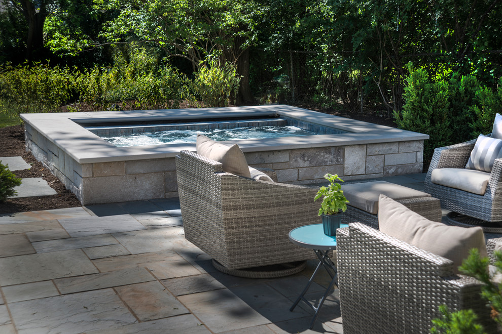 Inspiration for a small timeless backyard stone and rectangular natural hot tub remodel in Chicago