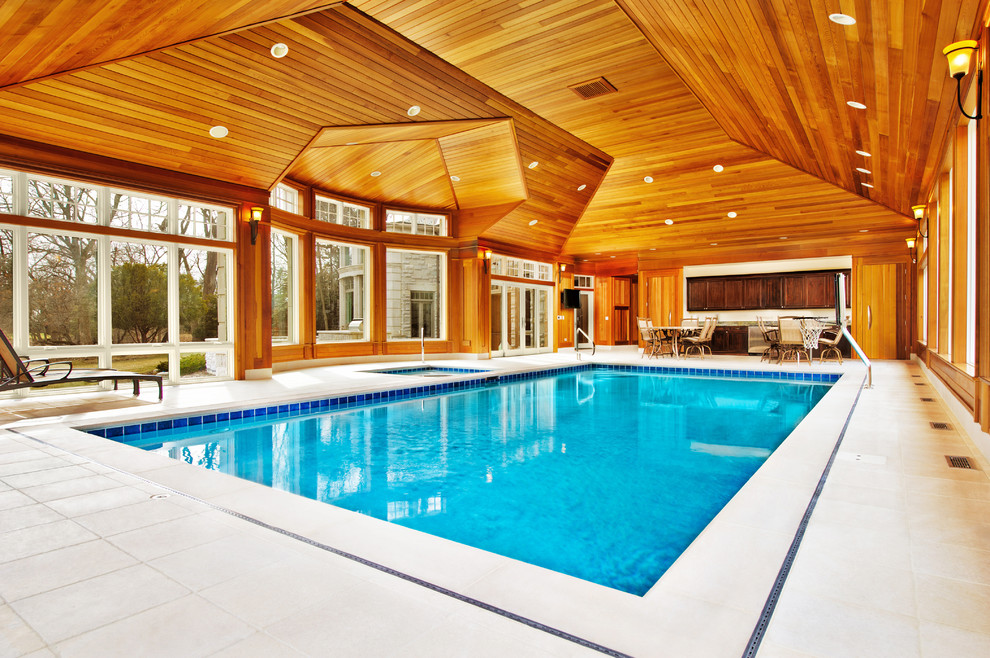 Inspiration for a medium sized traditional indoor rectangular lengths hot tub in Chicago with natural stone paving.