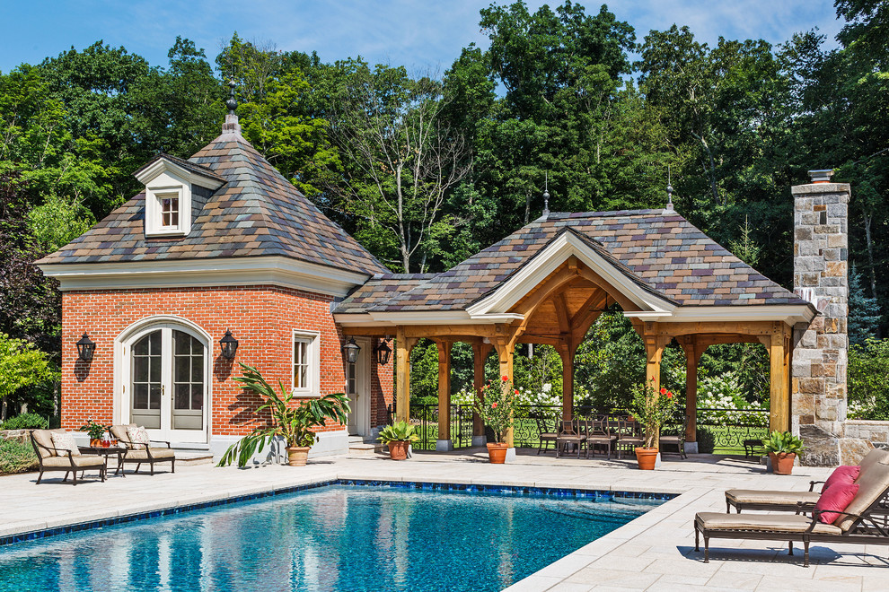 Traditional rectangular swimming pool in New York with a pool house.