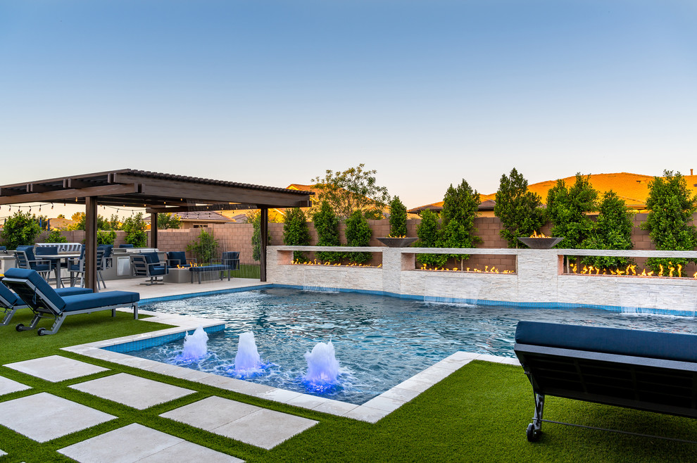 Imagen de piscina con fuente actual grande rectangular en patio trasero