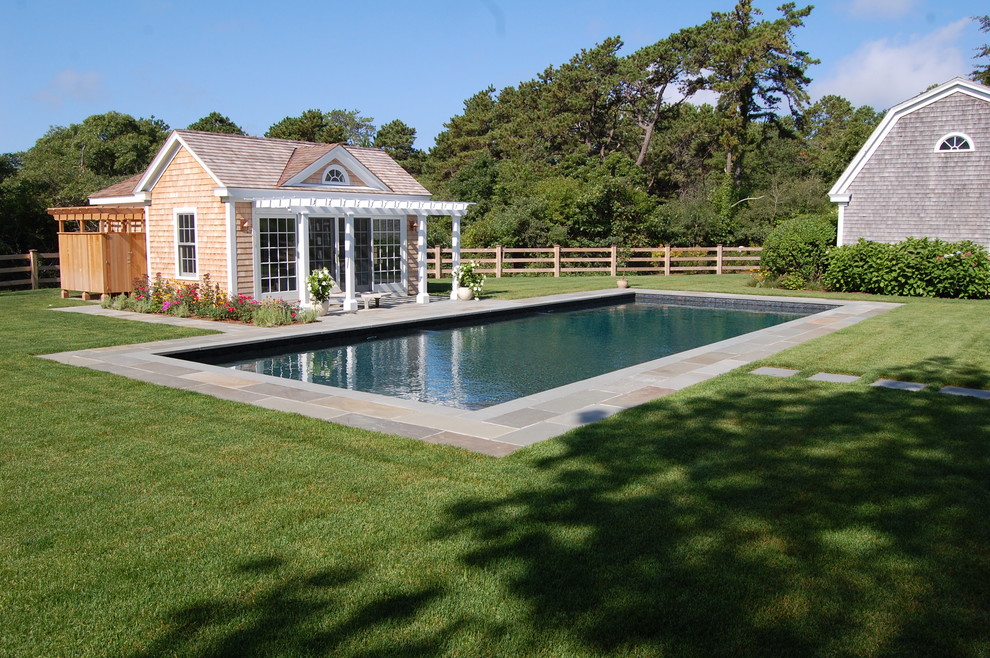 Medium sized traditional back rectangular lengths swimming pool in Boston with a pool house and tiled flooring.