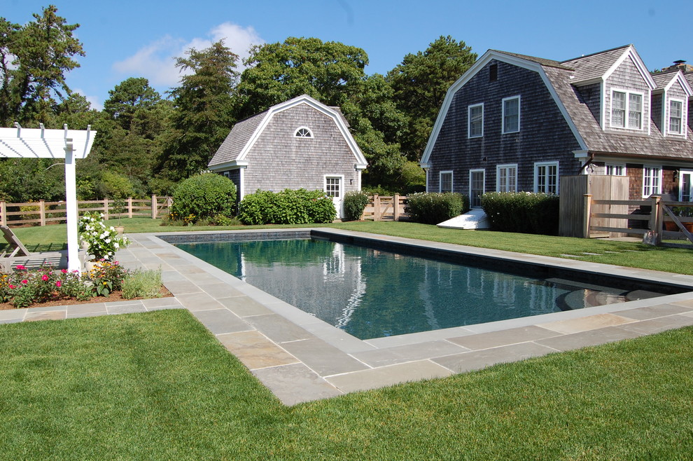 This is an example of a medium sized classic back rectangular lengths swimming pool in Boston with a pool house and tiled flooring.