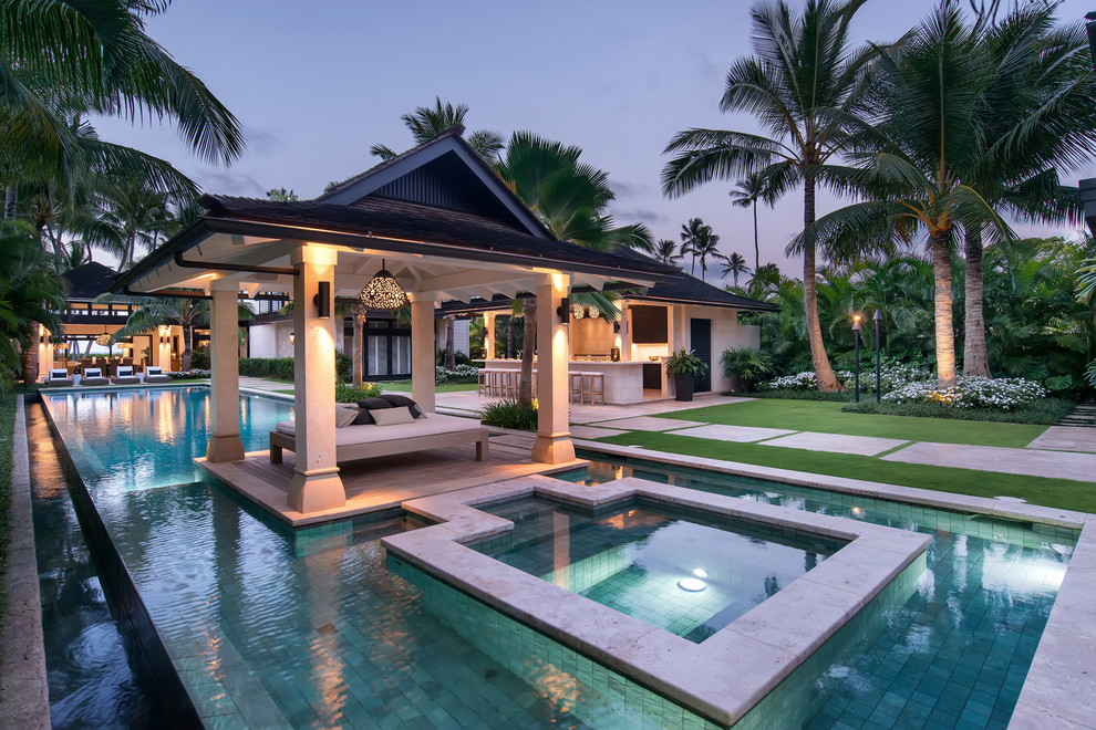 Example of a beach style side yard tile and rectangular pool design in Hawaii