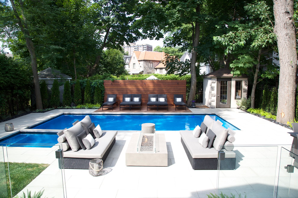 This is an example of a medium sized contemporary back rectangular lengths hot tub in Montreal with concrete paving.