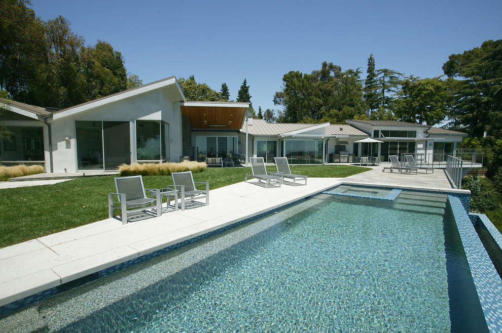 Идея дизайна: прямоугольный бассейн-инфинити в современном стиле с покрытием из декоративного бетона