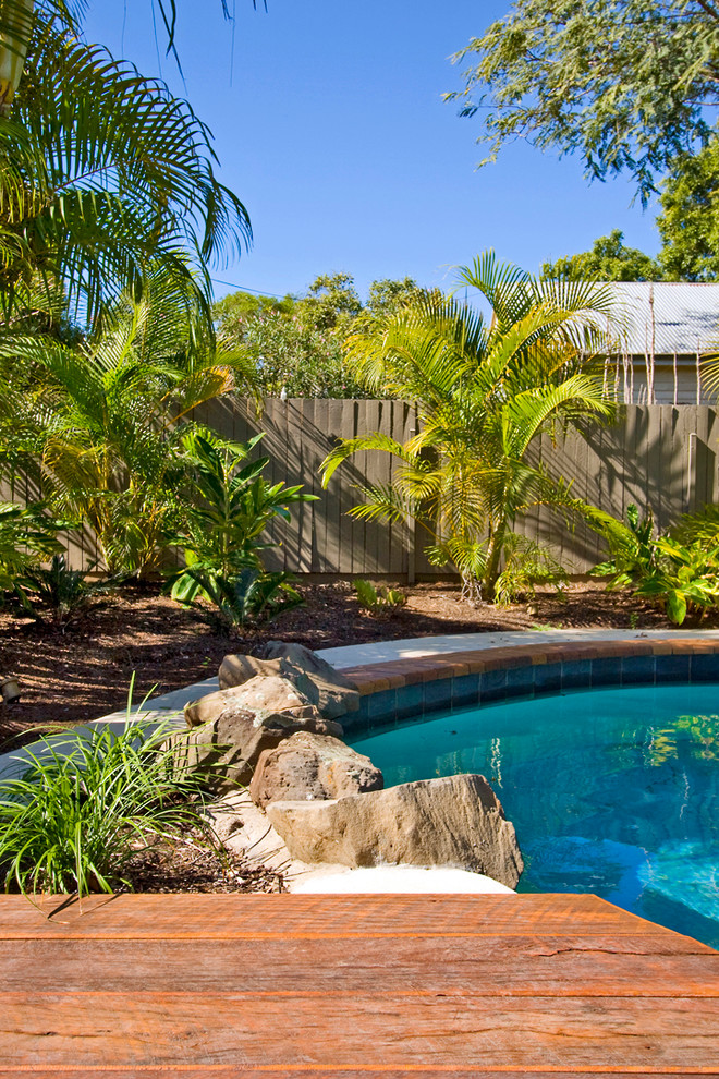 Inspiration for a large traditional back custom shaped swimming pool in Brisbane.