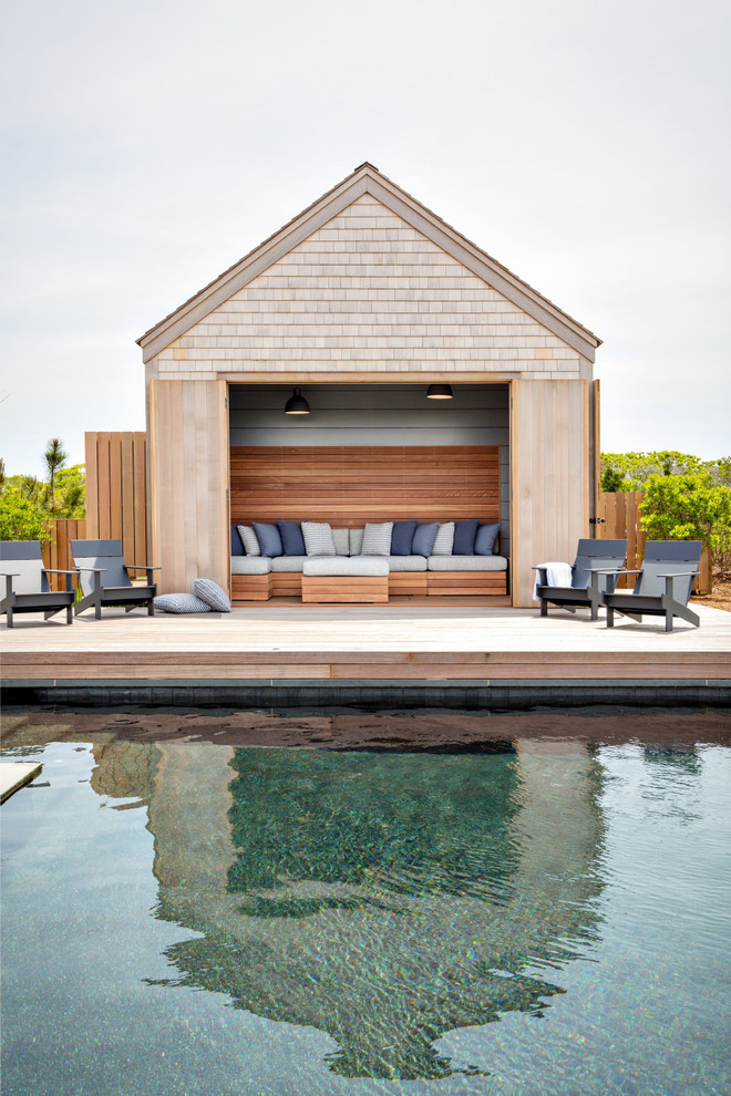 Inspiration for a contemporary swimming pool in Boston with a pool house and decking.
