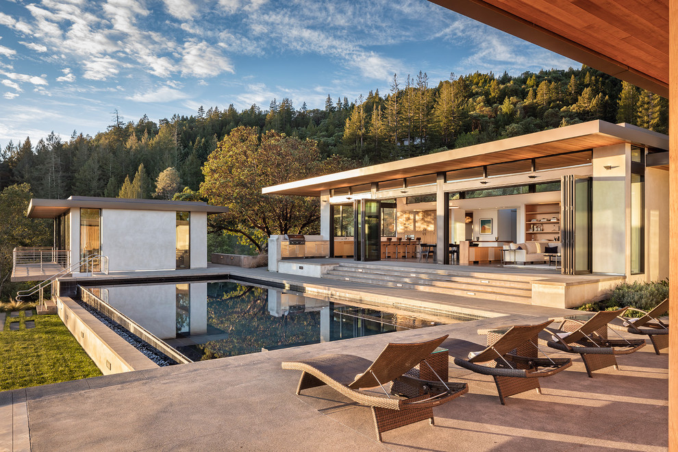 Example of a large trendy backyard tile and rectangular infinity pool design in San Francisco