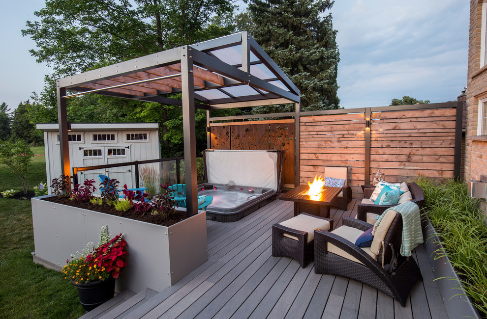 Design ideas for a contemporary back hot tub in Toronto with decking.