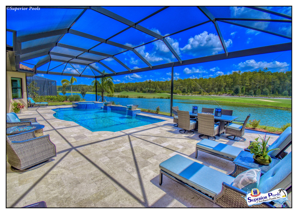 Large elegant backyard stone and rectangular lap pool house photo in Tampa