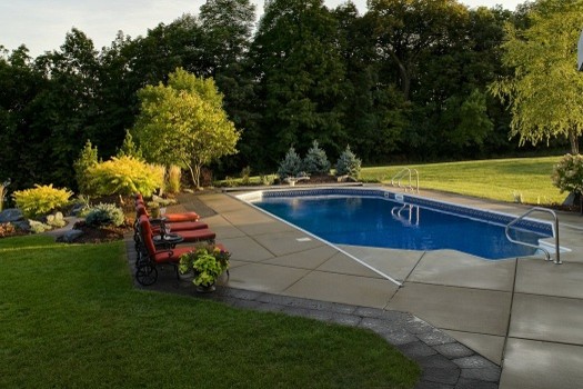 Design ideas for a medium sized traditional back rectangular lengths swimming pool in Minneapolis with concrete paving.