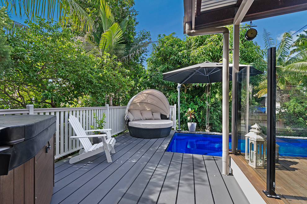Aménagement d'une piscine arrière bord de mer rectangle avec une terrasse en bois.