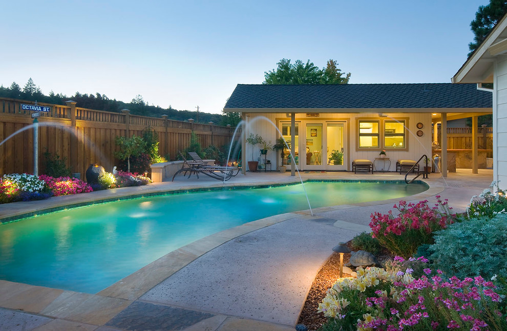 This is an example of a traditional custom shaped swimming pool in San Francisco with a water feature.