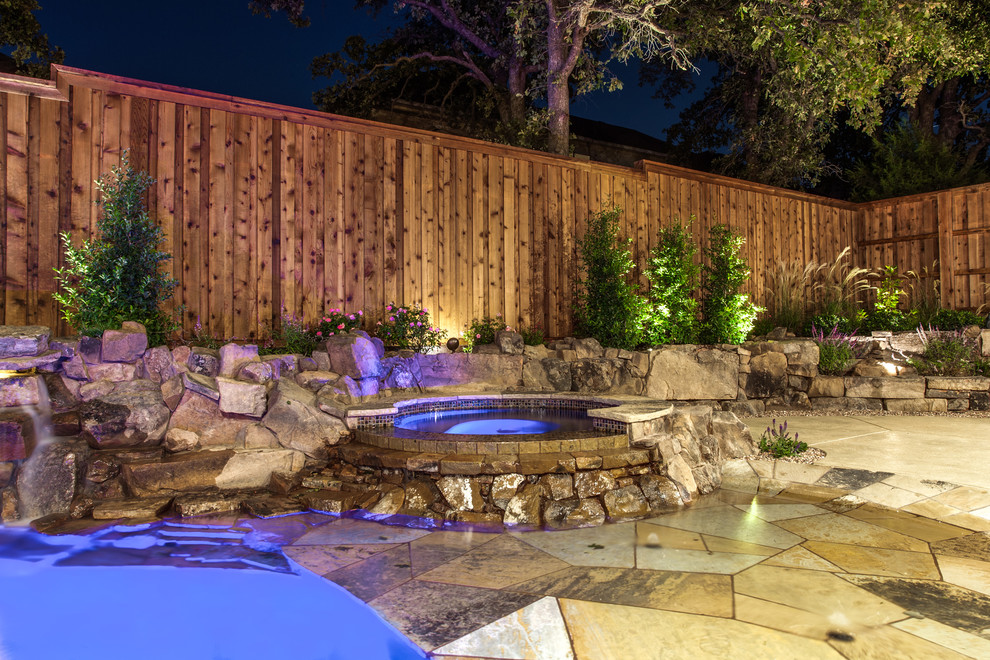 Small island style backyard custom-shaped natural hot tub photo in Dallas