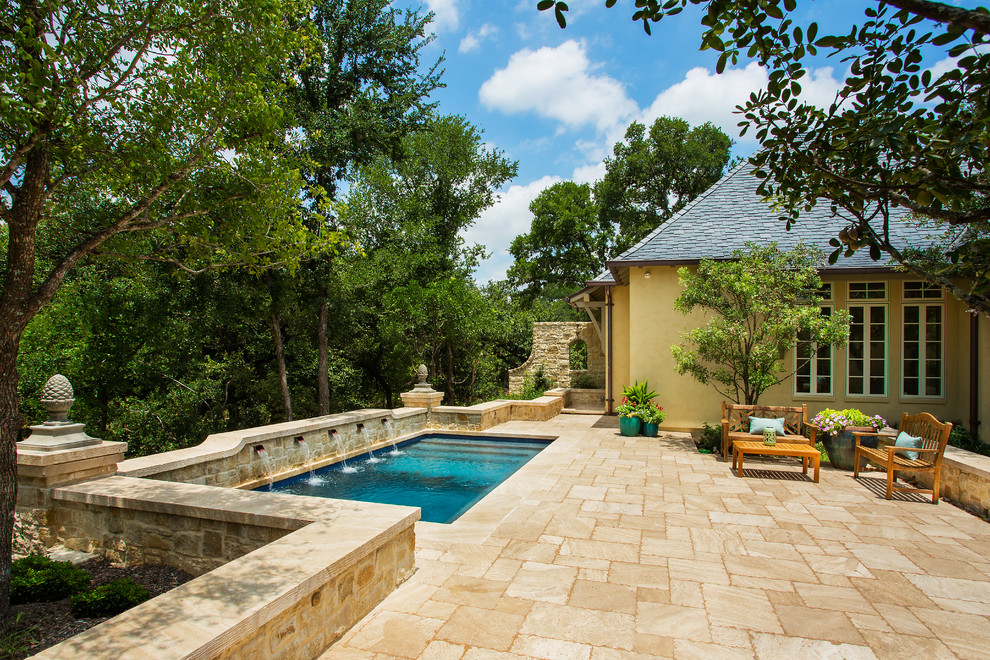 Design ideas for a mediterranean back rectangular lengths swimming pool in Other with natural stone paving and fencing.