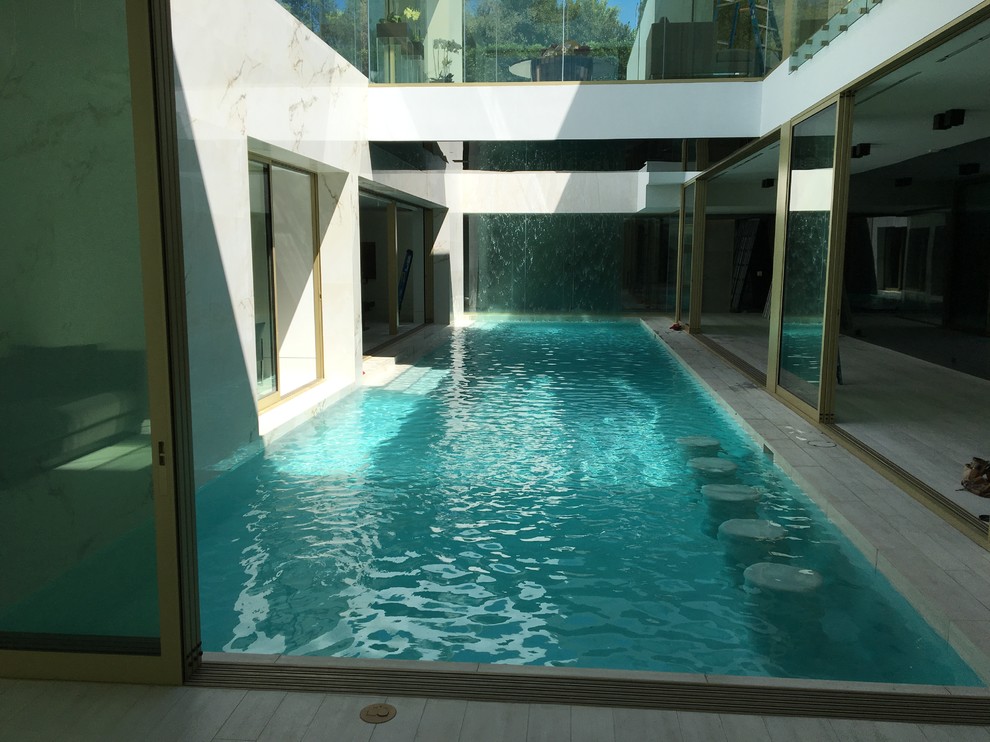 This is an example of a large modern indoor l-shaped lengths swimming pool in Los Angeles.