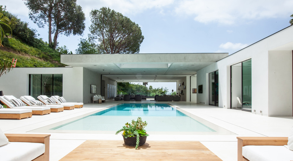 Huge trendy backyard concrete and rectangular infinity pool photo in Los Angeles