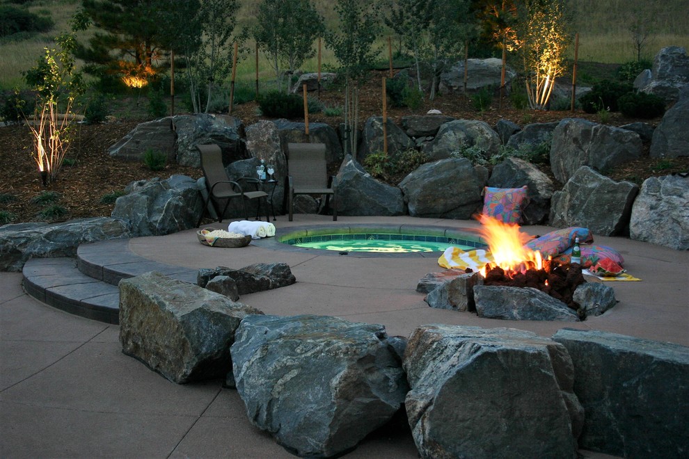 Design ideas for a contemporary back round natural hot tub in Other with stamped concrete.