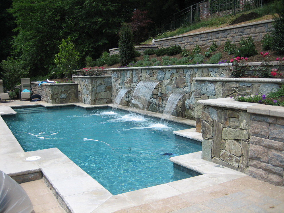Mid-sized minimalist backyard custom-shaped and concrete paver lap pool fountain photo in DC Metro