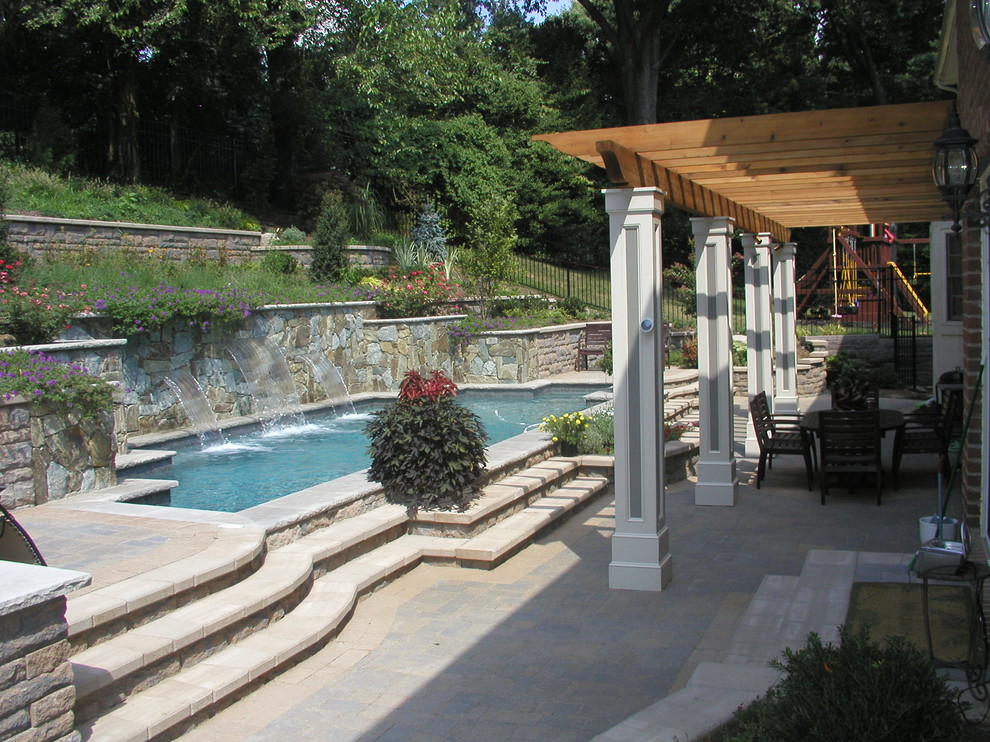 Inspiration for a mid-sized modern backyard custom-shaped and concrete paver lap pool fountain remodel in DC Metro