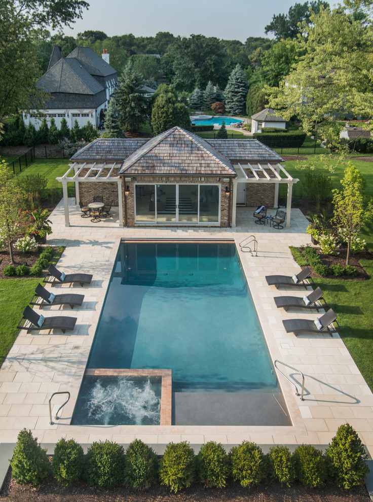 Photo of a medium sized traditional back rectangular lengths hot tub in Chicago with natural stone paving.