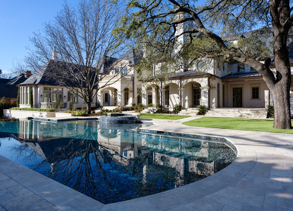 Inspiration for a large traditional back custom shaped lengths hot tub in Dallas with natural stone paving.