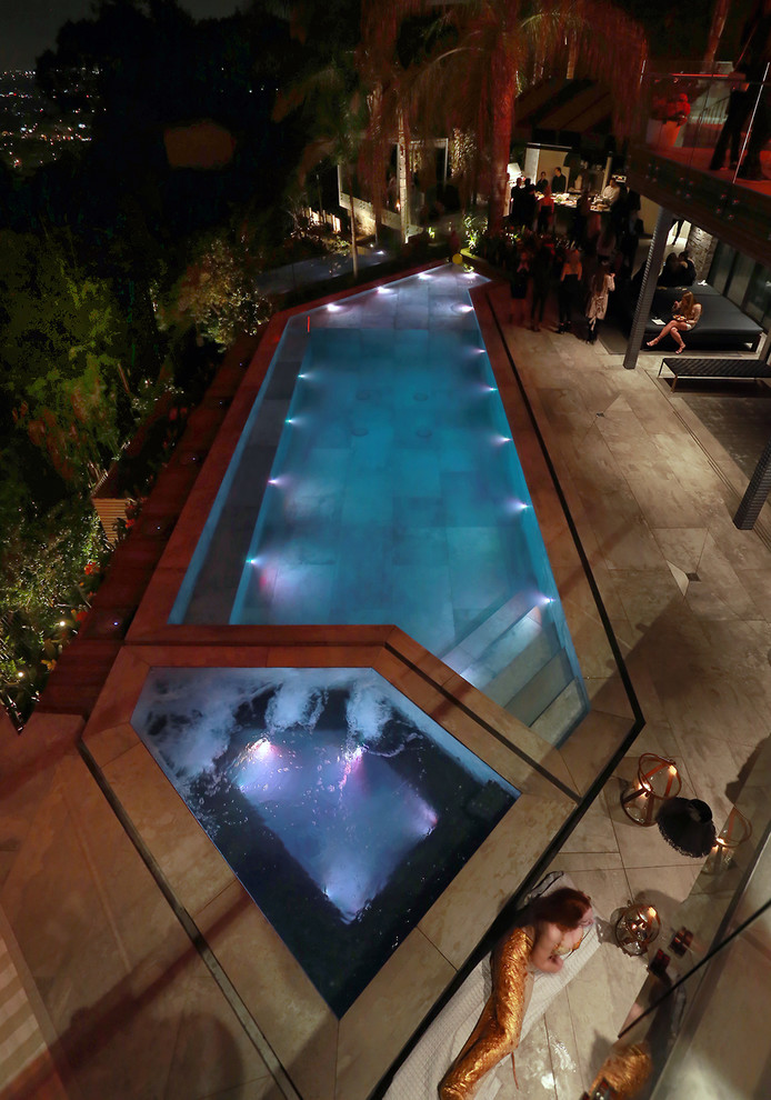 Pool fountain - mid-sized modern backyard tile and custom-shaped infinity pool fountain idea in Los Angeles
