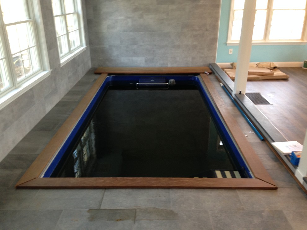 Design ideas for a small contemporary indoor rectangular lengths swimming pool in New York with tiled flooring.