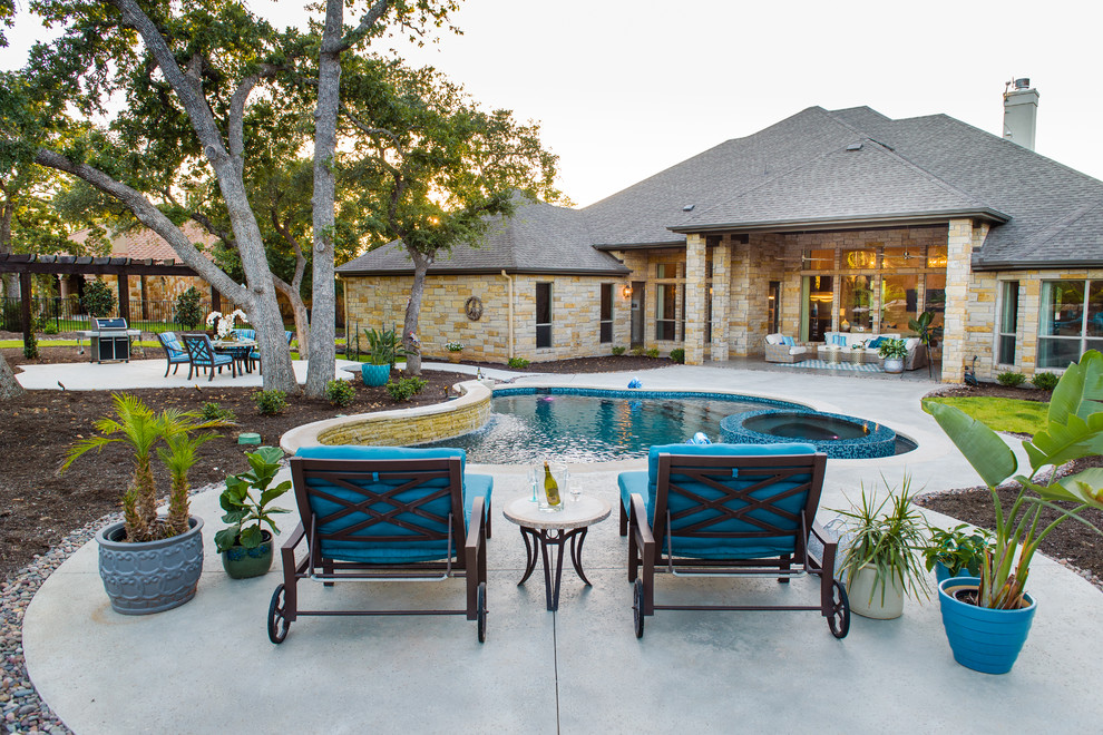 Inspiration for a medium sized contemporary back custom shaped natural hot tub in Austin with stamped concrete.