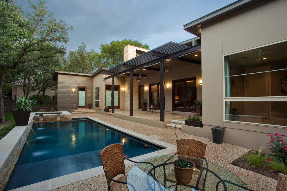 This is an example of a contemporary rectangular swimming pool in Austin.