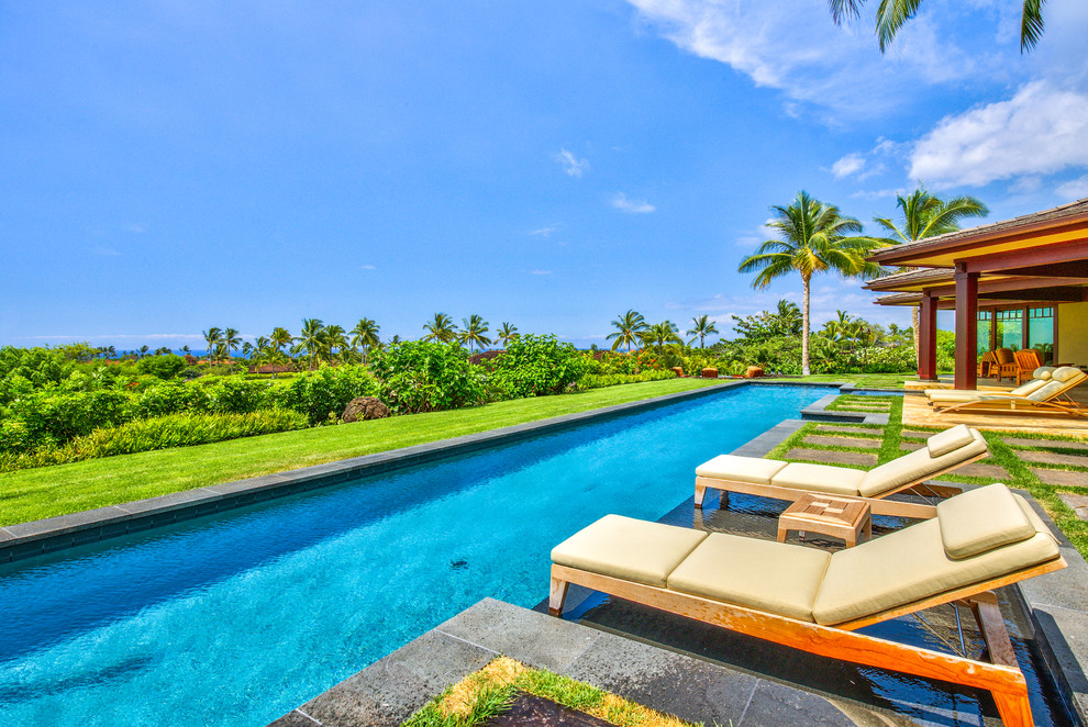 Inspiration for a mid-sized tropical backyard concrete paver pool remodel in Hawaii