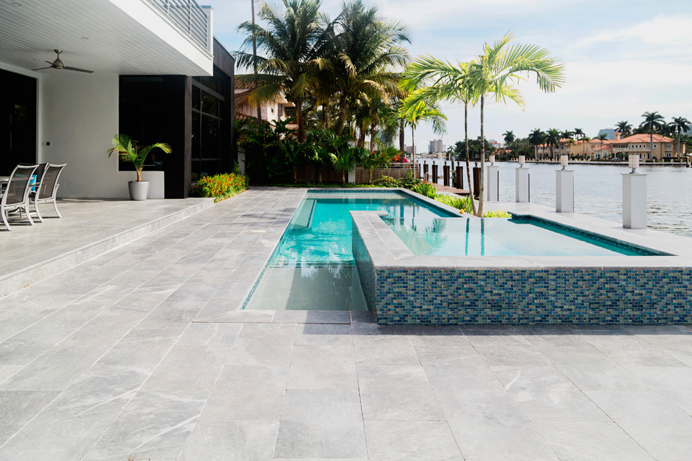 Design ideas for a medium sized modern back custom shaped hot tub in Miami.