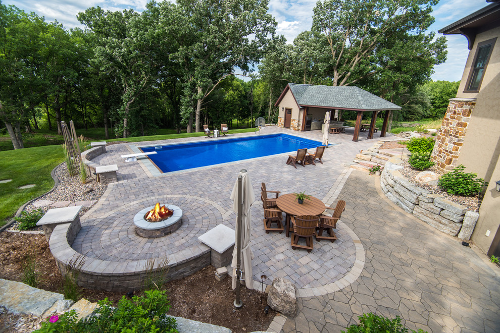 Inspiration for a large backyard brick and rectangular pool house remodel in Minneapolis