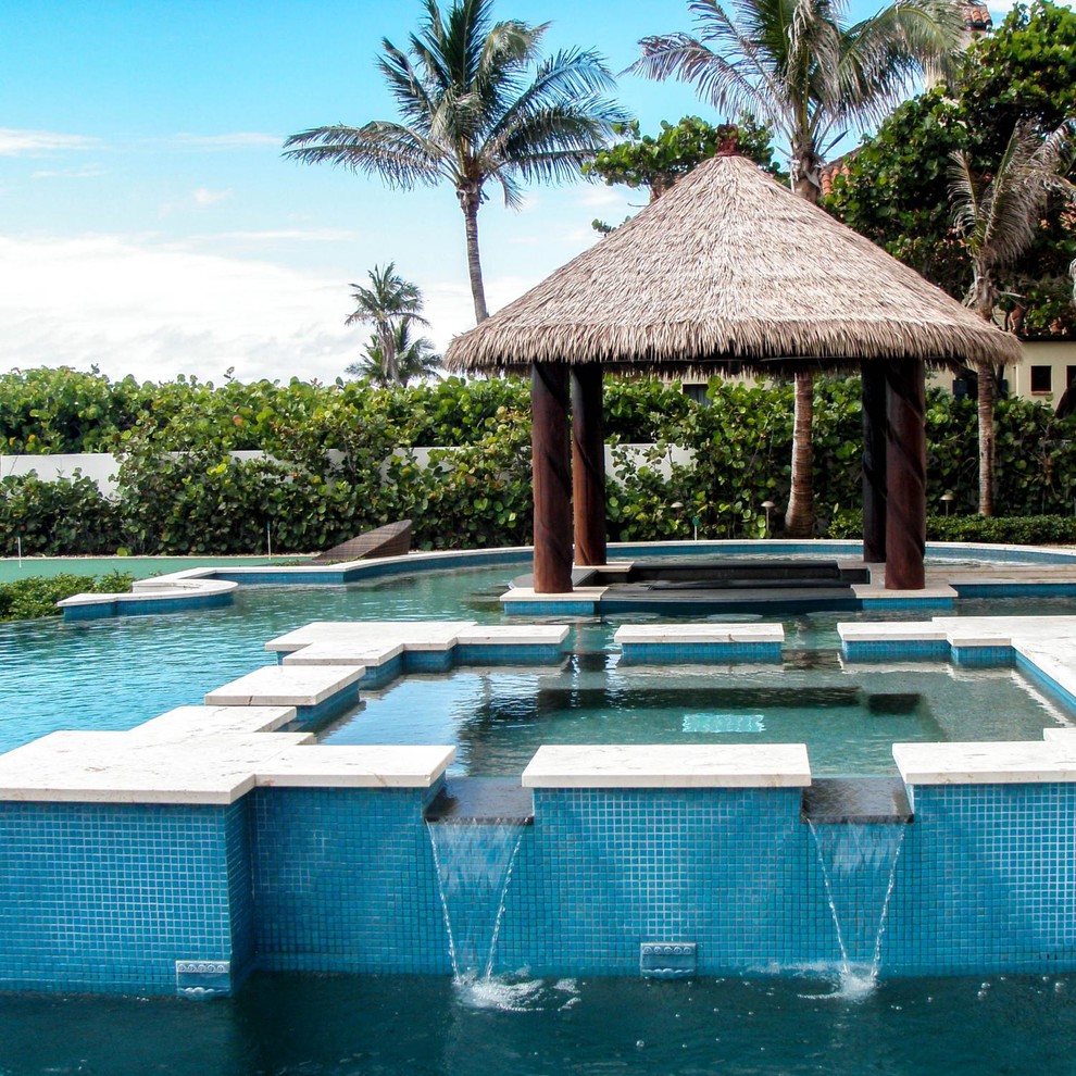 Inspiration for a tropical custom-shaped pool fountain remodel in Miami