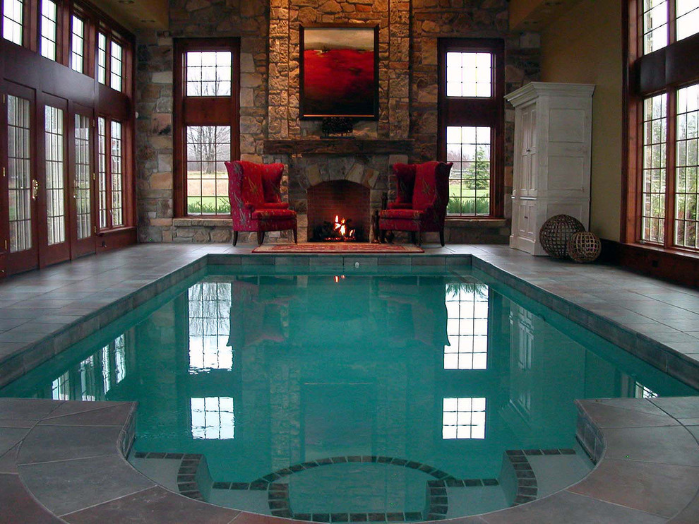 Huge elegant indoor tile and rectangular lap pool house photo in Cleveland